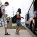 Pioneer junior James Sazyc and others board a bus on the new Ann Arbor Transportation Authority bus route on Waters Road on Tuesday. Daniel Brenner I AnnArbor.com